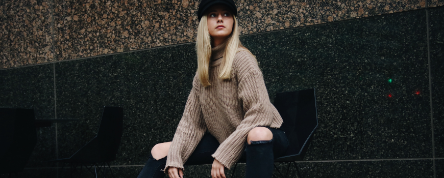 blonde woman with hat on bench